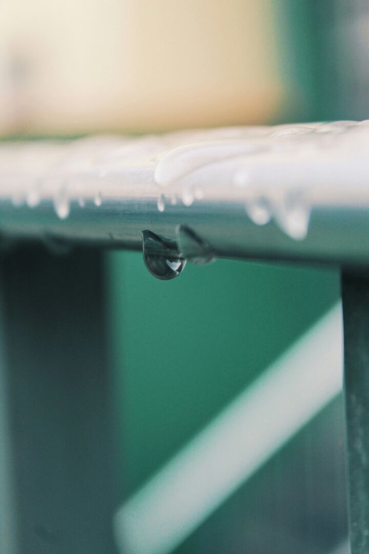 a close up of a water drop on a bench